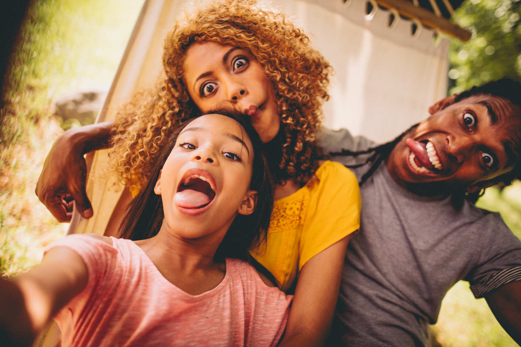 Lovely African-American family making silly faces and posing